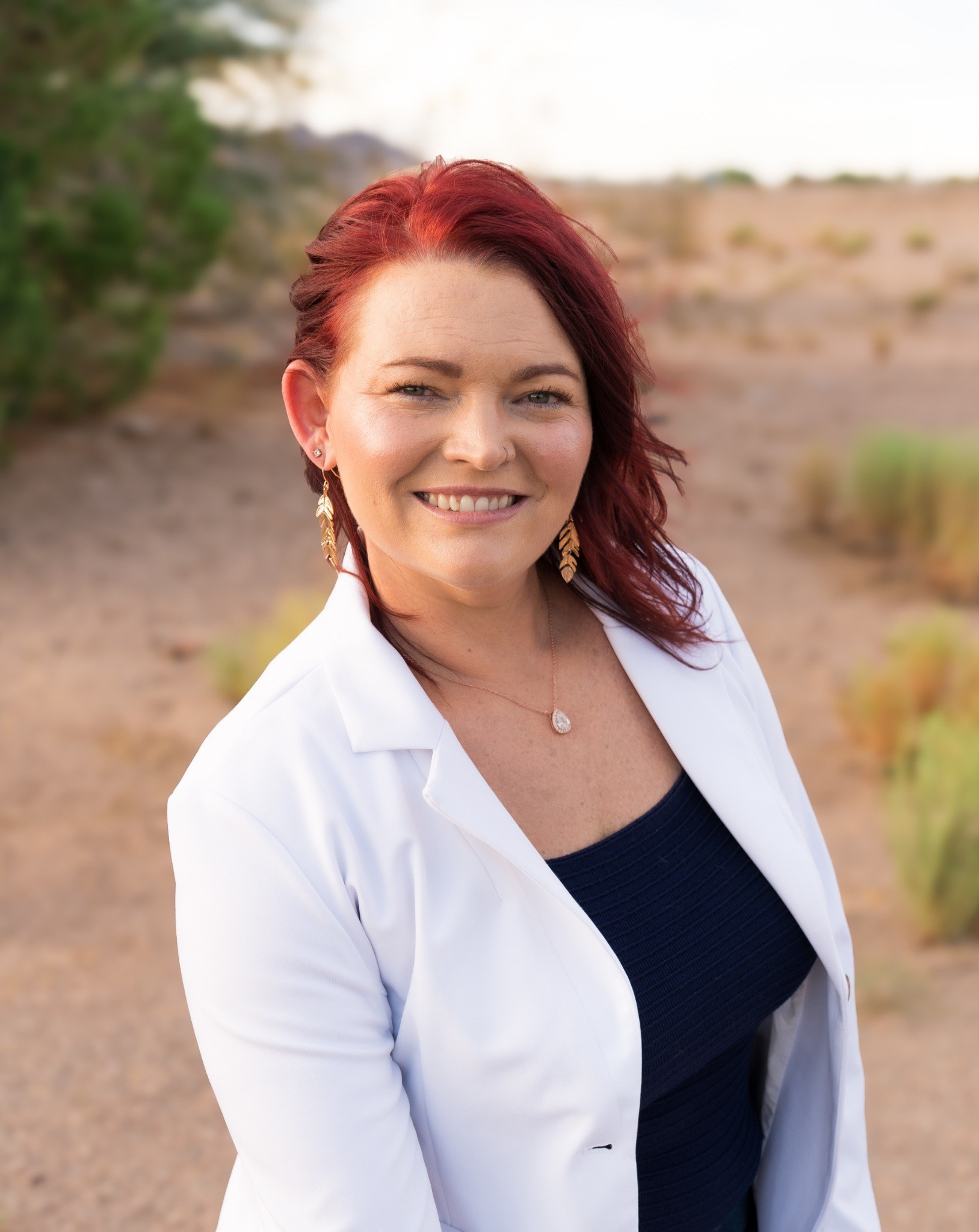 Katelin M. Provost smiling outdoors in a white jacket